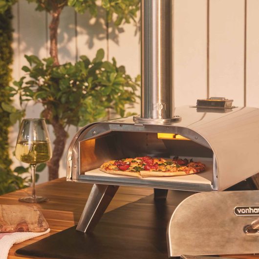 a vegetable pizza in a silver pizza oven