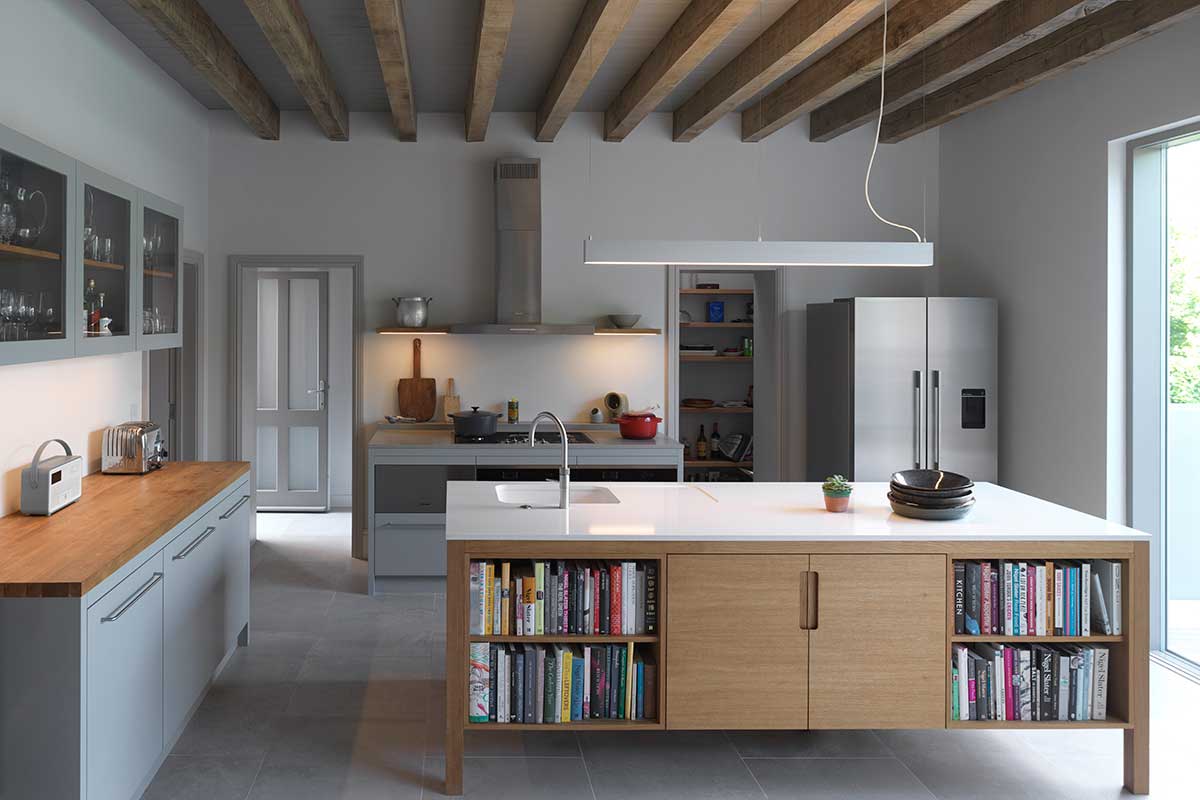 A monochrome kitchen with a layered lighting scheme and large glazing
