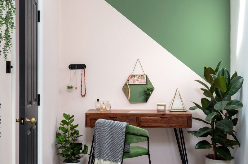 Green bedroom design with a small dressing area